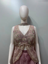 Close view of the embroidery on a dusty pink kurta and palazzo