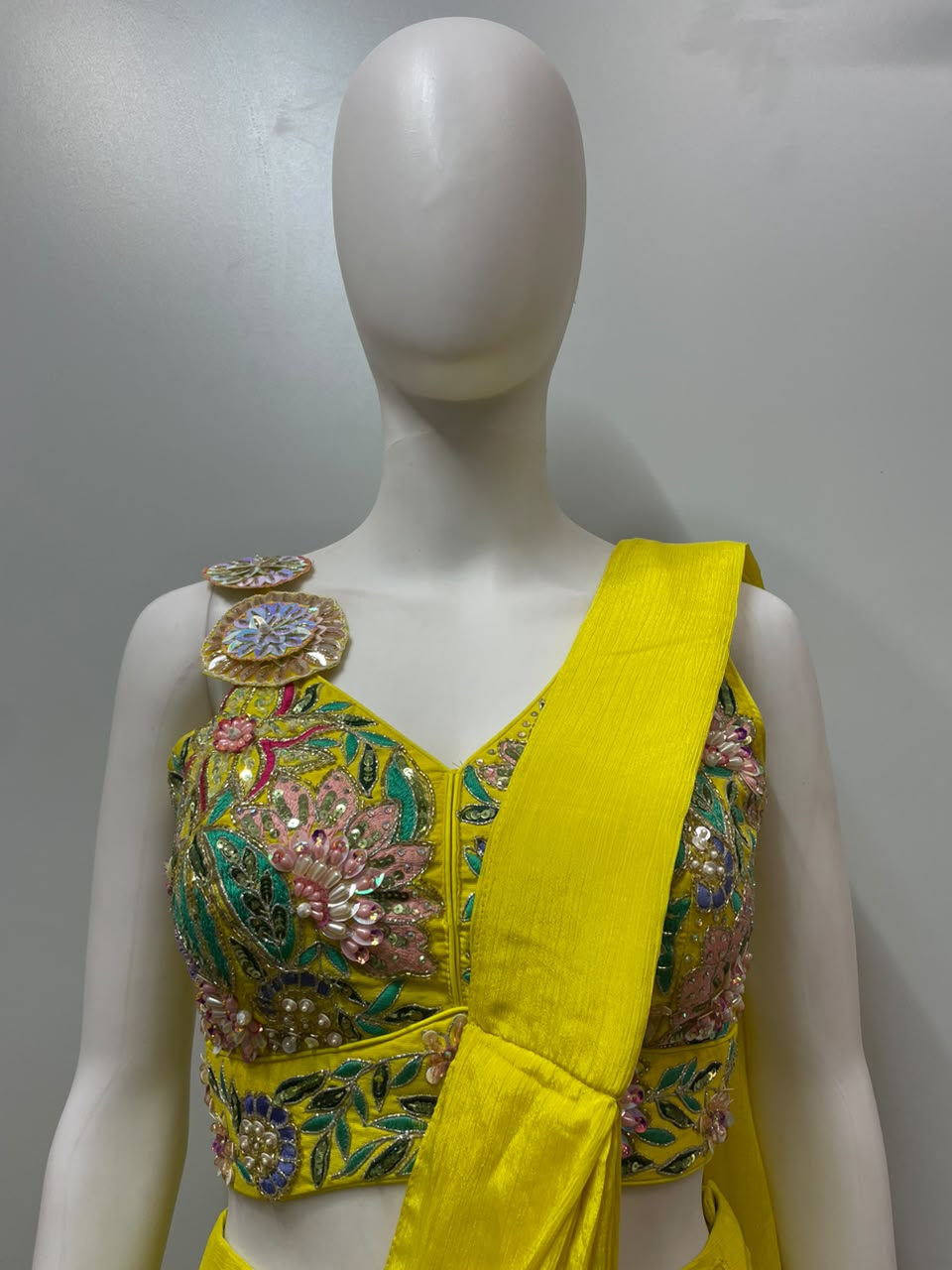 Close view of the floral embroidery on a sunshine yellow palazzo set