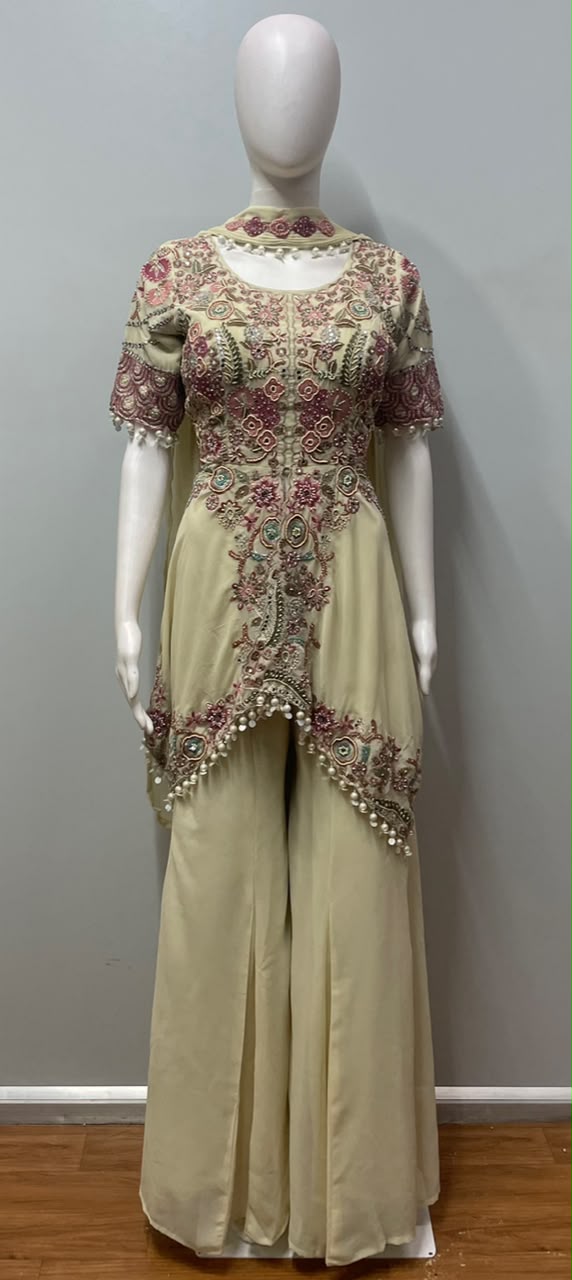 Full-length view of an ivory blush peplum and palazzo ensemble