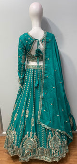 Flared peacock teal lehenga skirt with peacock motifs along the antique gold hem