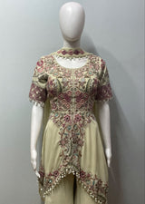 Detail of the peplum hem on an ivory and blush palazzo ensemble