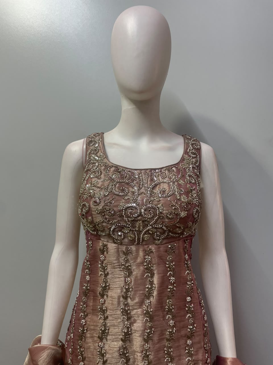 Symmetrical vine and paisley embellishment on the rose taupe longline top