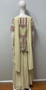 Close view of the embroidery on an ivory and blush peplum top