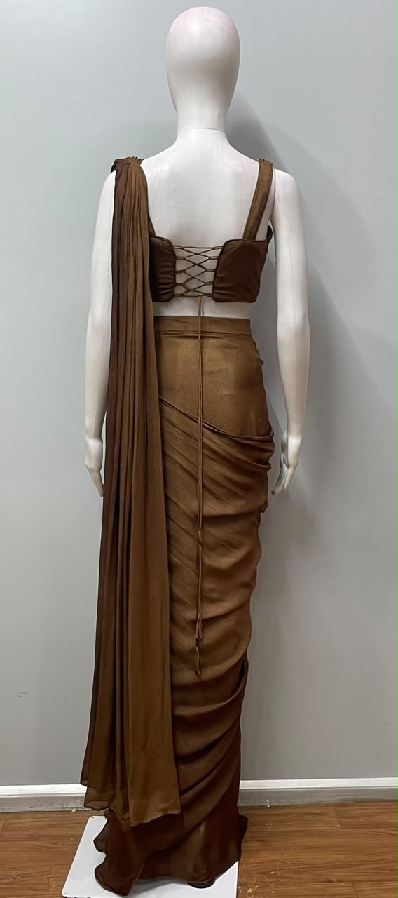 Copper bronze corset saree photographed against a plain backdrop