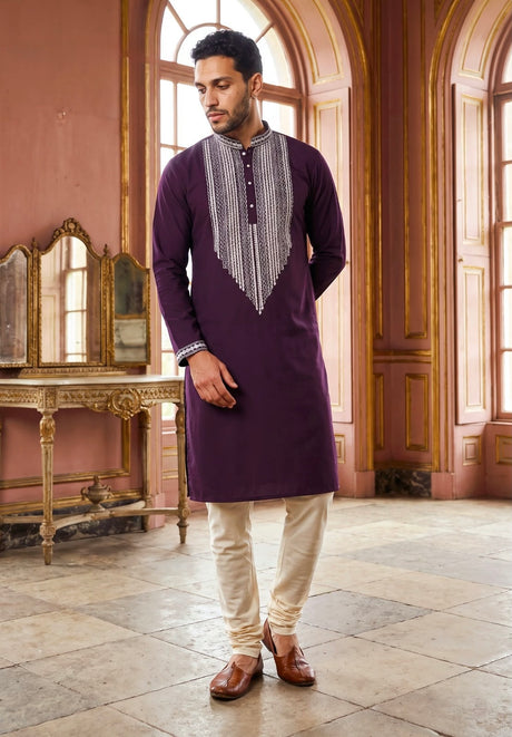 Royal purple men's kurta set with a silver-detailed pointed chest panel and ivory tapered trousers