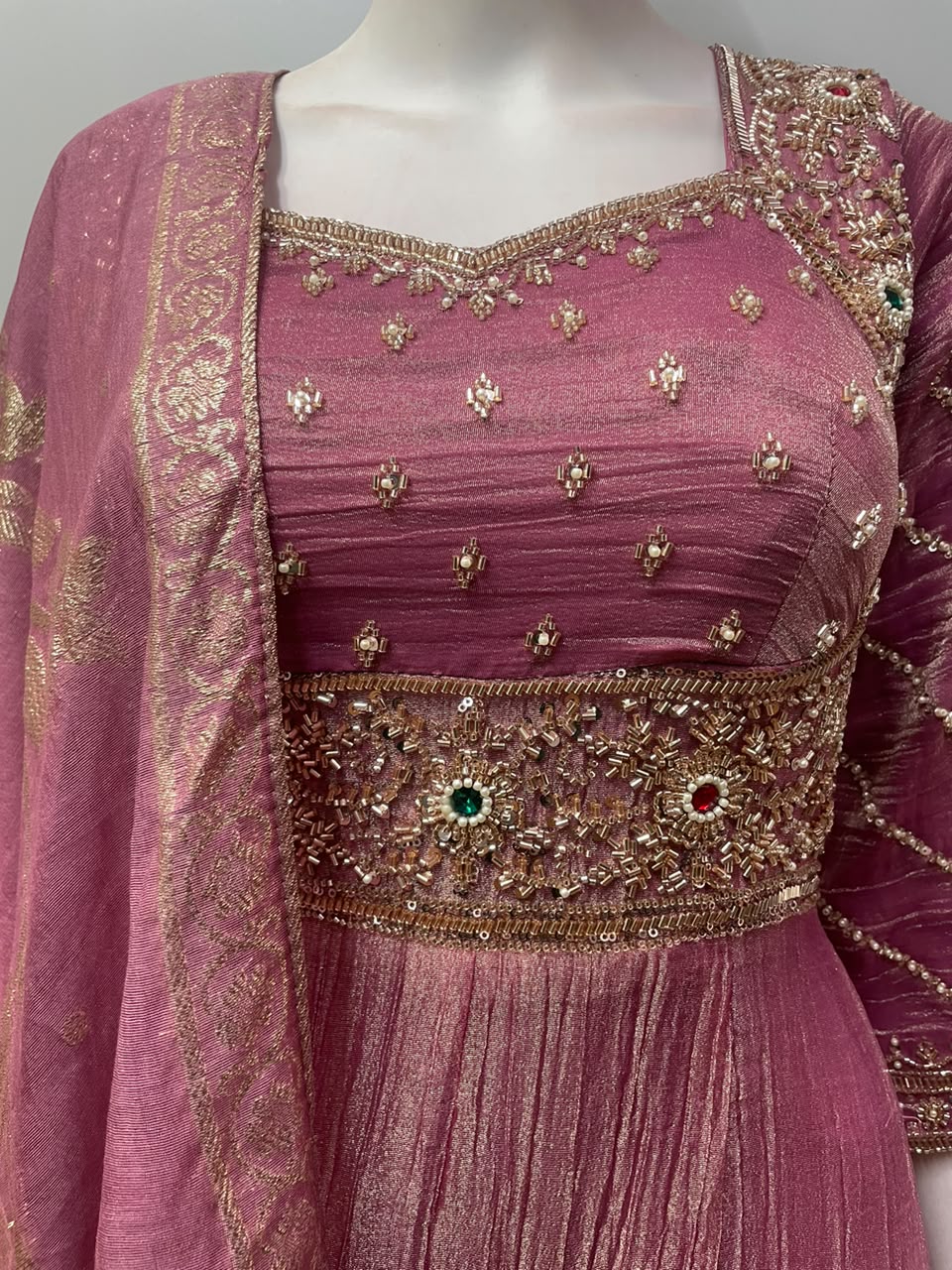 Antique gold beadwork framing the Anarkali neckline