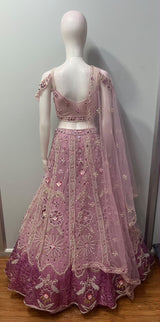 Flared dusty mauve lehenga skirt with vertical pearl trails and a deep plum peacock hem