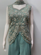 Sheer scalloped peplum layer over the dusty teal waist