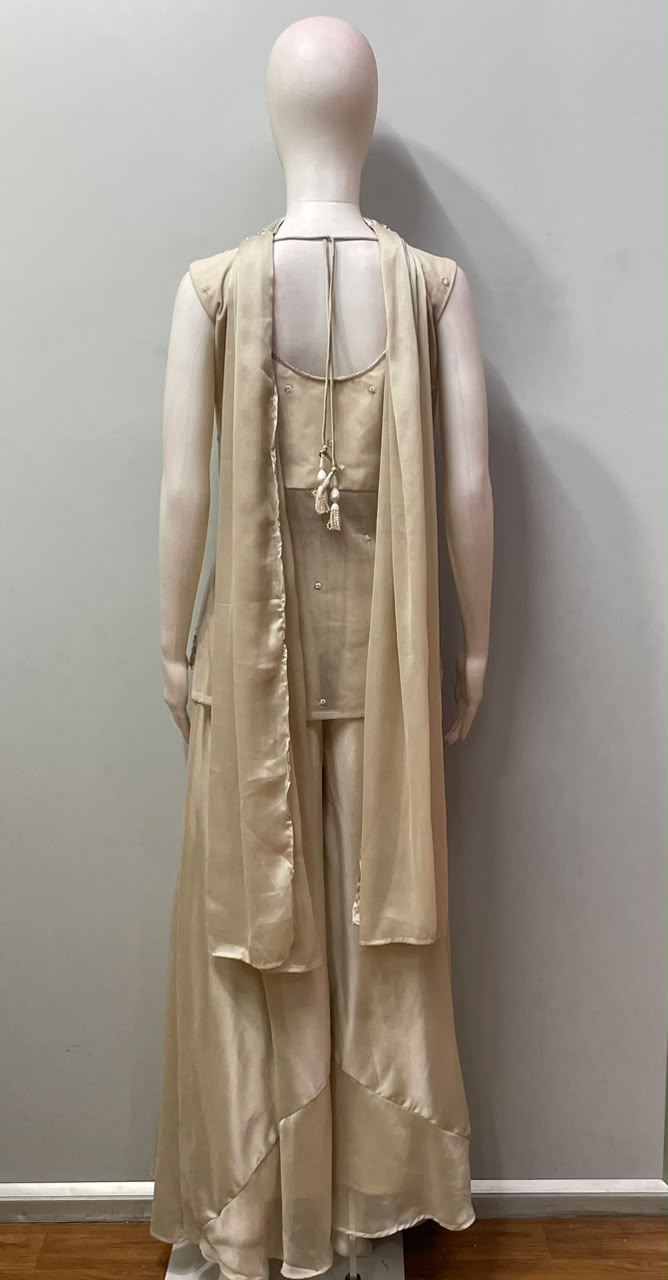 Flowing wide-leg trousers worn with the champagne gold peplum top