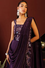 Pleated shoulder drape falling across the deep plum saree gown