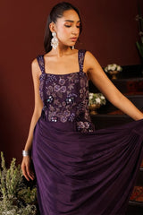 Embroidered vine trailing down the side of the plum draped gown