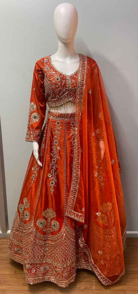 Copper orange blouse with emerald and ruby toned jewel accents and gold beadwork