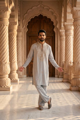 Pearl grey men's kurta with an ornate champagne gold embroidered neckline