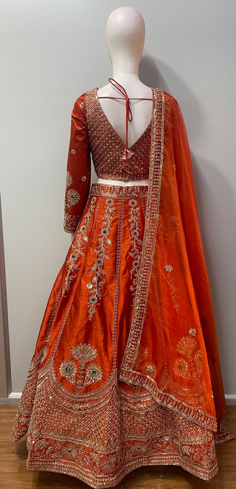 Flared copper orange lehenga skirt with lattice and floral antique gold hem border