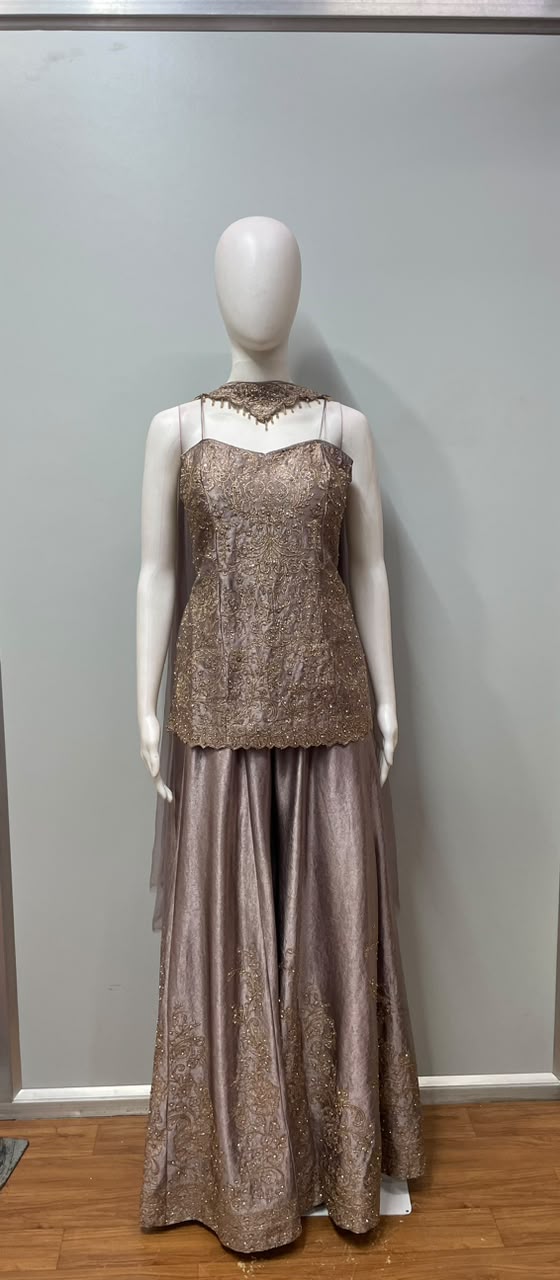 Close view of the gold embroidery on a mauve kurta and palazzo