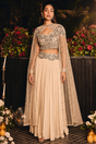 Champagne pleated skirt set with a beaded sweetheart blouse and sheer cape