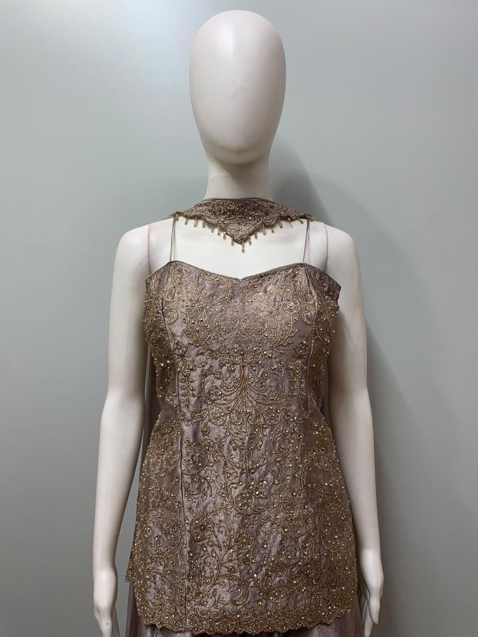 Detail of the neckline on a mauve gold embroidered kurta set