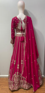 Flared fuchsia lehenga skirt with vertical floral trails and an antique gold hem border