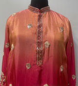 Gold peacock and floral border detail on a coral crimson men's kurta
