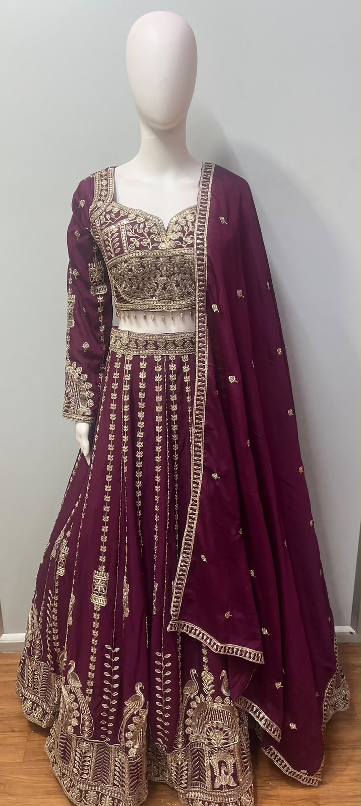 Asymmetric one-sleeve blouse with antique gold beadwork on the deep plum lehenga set