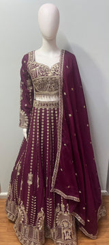 Asymmetric one-sleeve blouse with antique gold beadwork on the deep plum lehenga set
