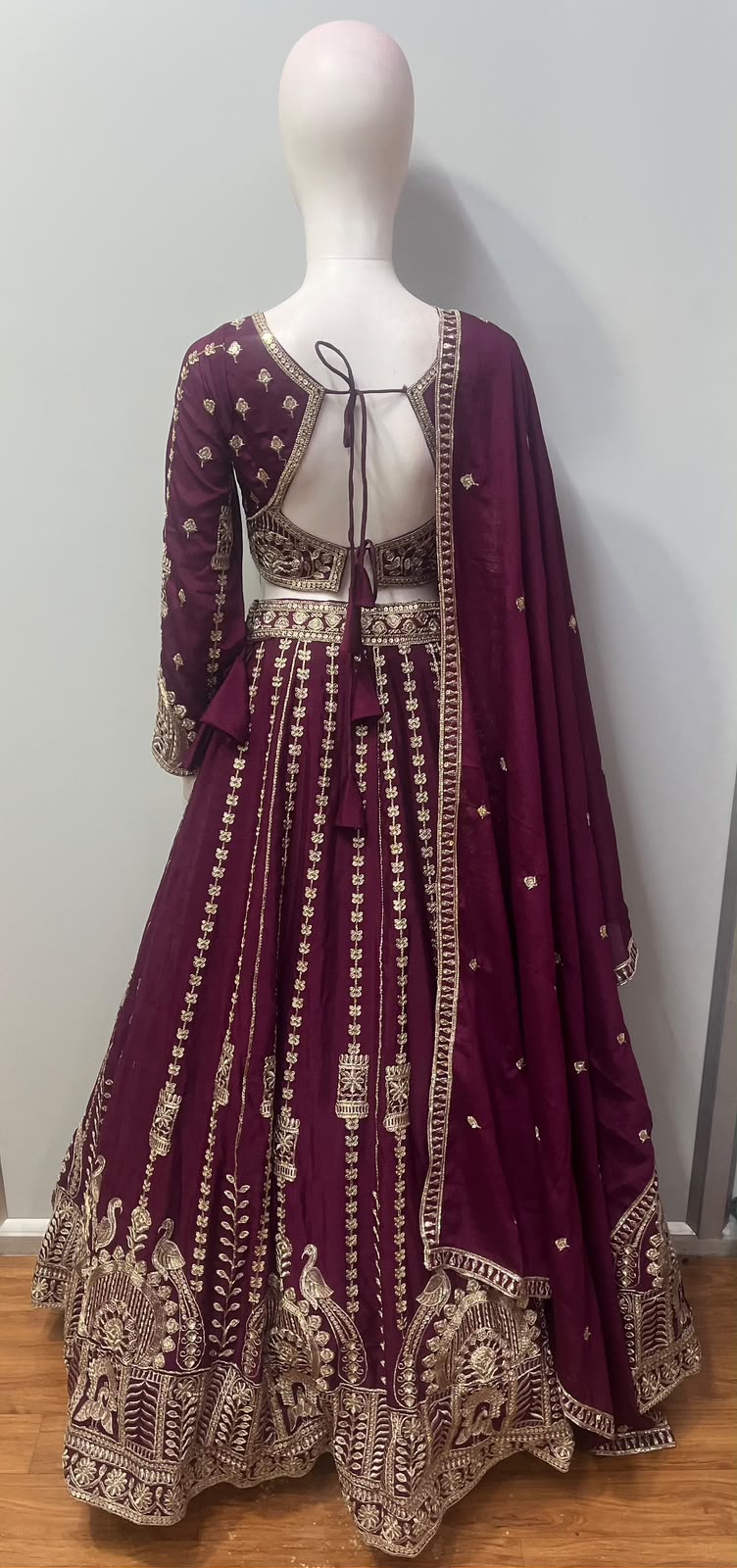 Flared deep plum lehenga skirt with an embroidered peacock and floral hem border