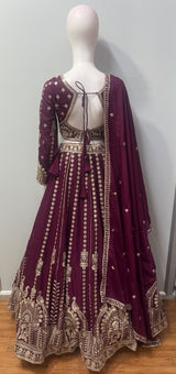 Flared deep plum lehenga skirt with an embroidered peacock and floral hem border