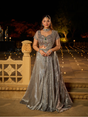 Antique silver draped lehenga with emerald and ruby jewel embellishment
