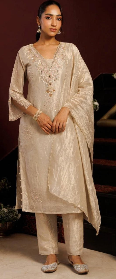 Ivory champagne kurta set with pearl beadwork and a softly draped dupatta