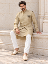 Champagne gold men's kurta with a Nehru waistcoat and ornate chest crest