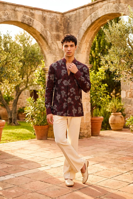 Burgundy men's jacket and trouser set with all-over botanical motifs and ivory trousers