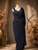 Navy pleats falling from the draped waist of the saree set