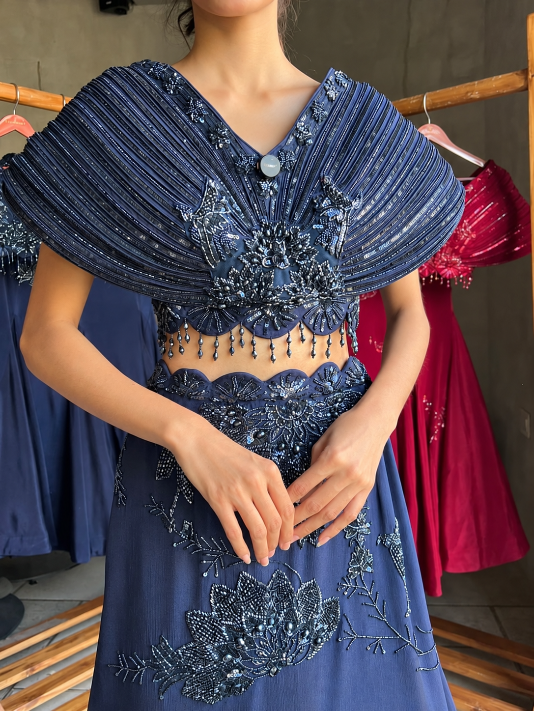 Midnight blue scalloped-waist skirt with beaded cape top, side view