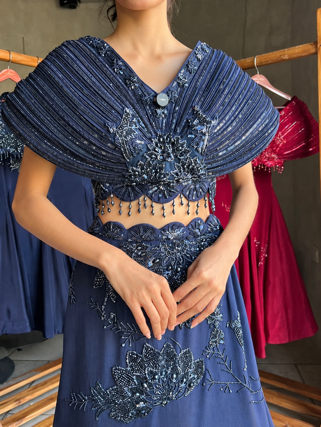 Midnight blue scalloped-waist skirt with beaded cape top, side view