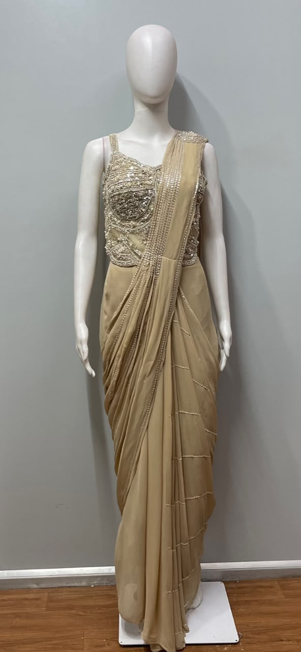 Back view of a champagne pearl draped saree and fitted blouse