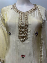 Side view of the champagne beige floral kurta set and its dupatta