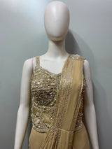 Champagne pearl draped saree photographed against a plain backdrop