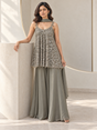 Sage grey palazzo set with silver mirrorwork, decorative straps and a flared kurta