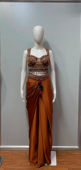 Close view of the embellishment on a copper rust draped skirt