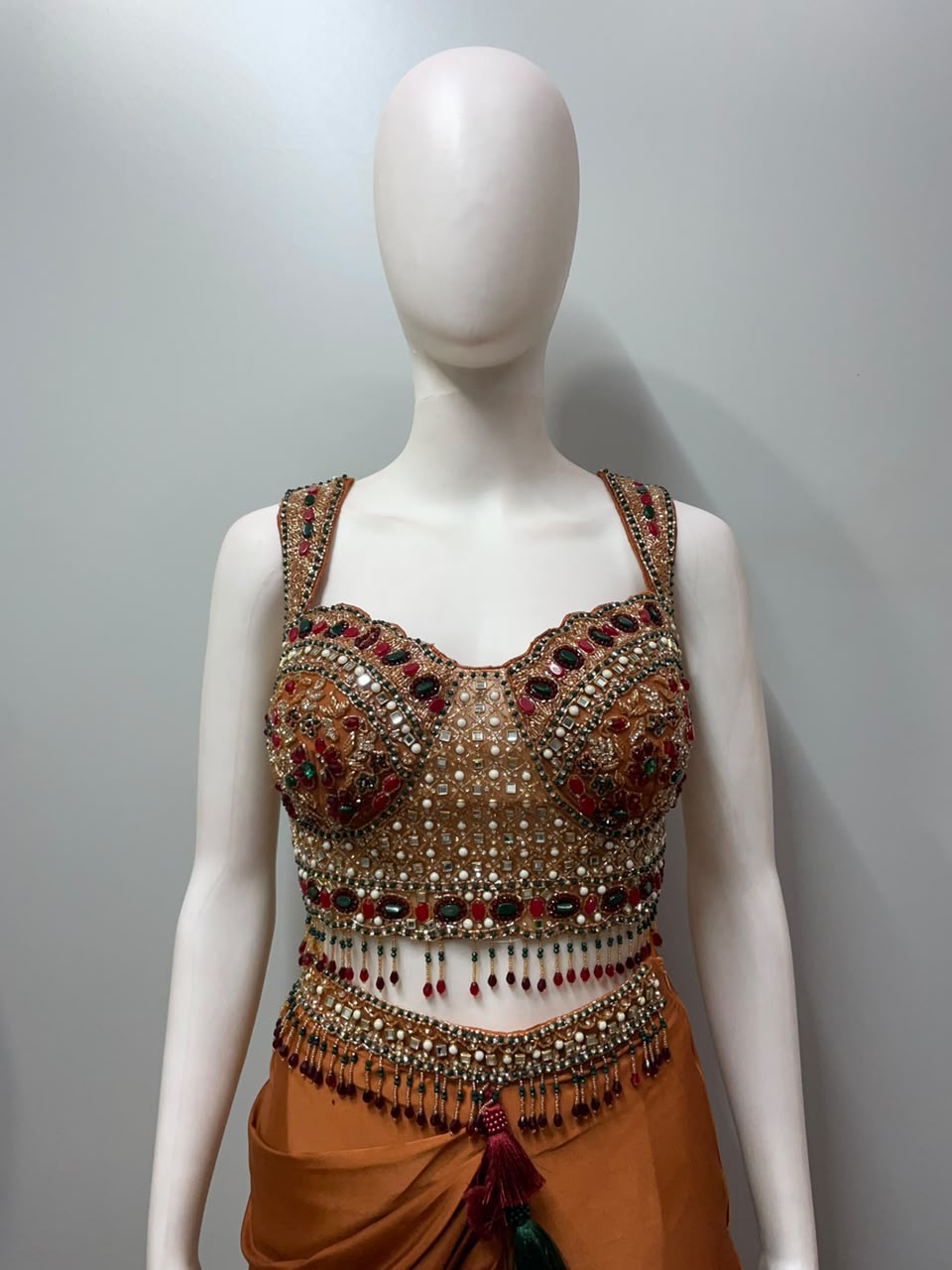 Detail of the drape and hem on a copper rust embellished skirt