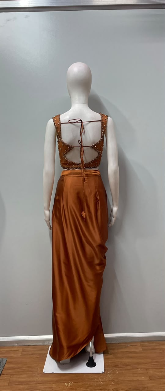 Copper rust draped skirt set styled for an evening celebration