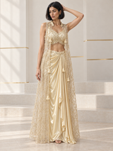 Champagne gold skirt set with a pearl-detail blouse, draped skirt and sheer floral cape