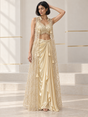 Champagne gold skirt set with a pearl-detail blouse, draped skirt and sheer floral cape
