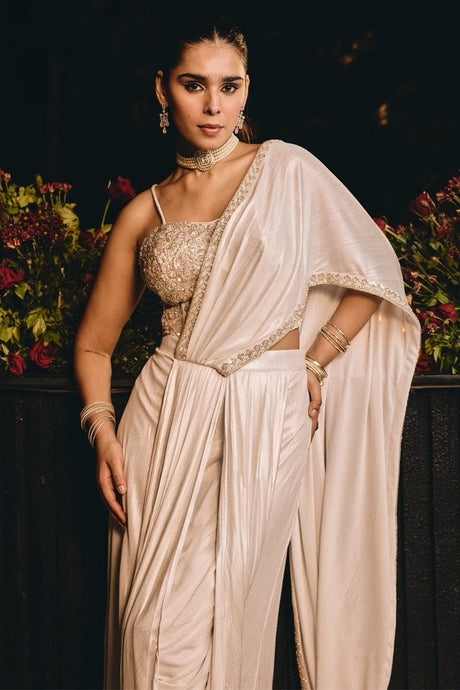 Champagne ivory bustier blouse with crystal beadwork over wide-leg draped pants