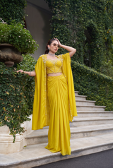 Lemon yellow saree worn with a pearl detailed cape and blouse