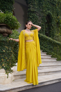 Lemon yellow saree worn with a pearl detailed cape and blouse