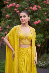 Full-length view of a lemon yellow pearl cape saree on the model
