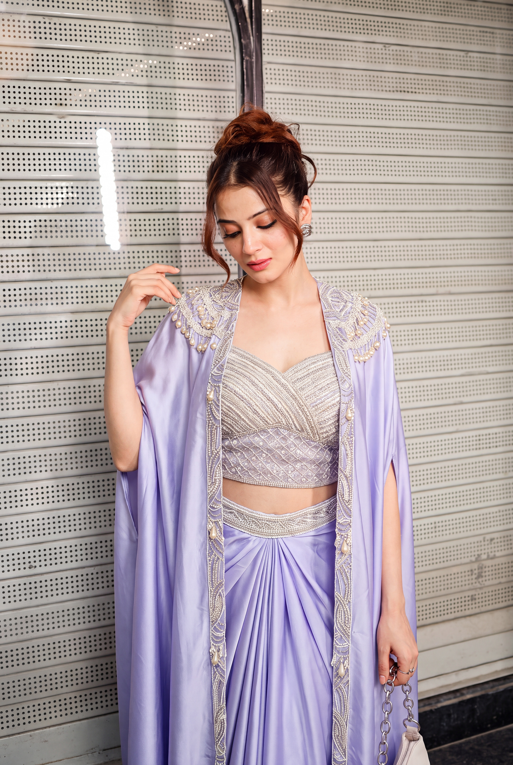 Full-length view of a lilac pearl cape saree set on the model