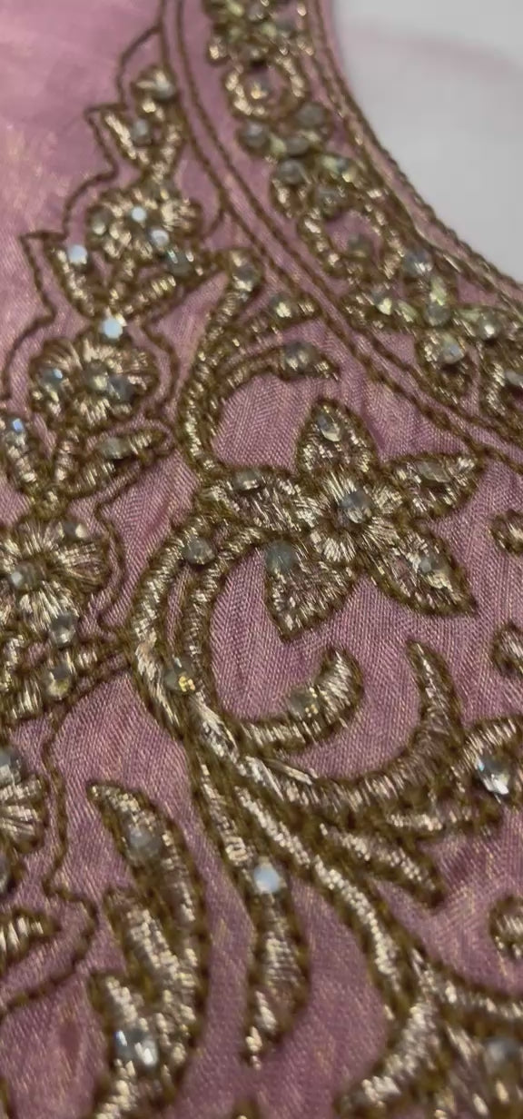 Dusty rose antique zari lehenga shown in movement on the model