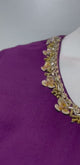 Wine and gold ruffle saree set shown in movement on the model